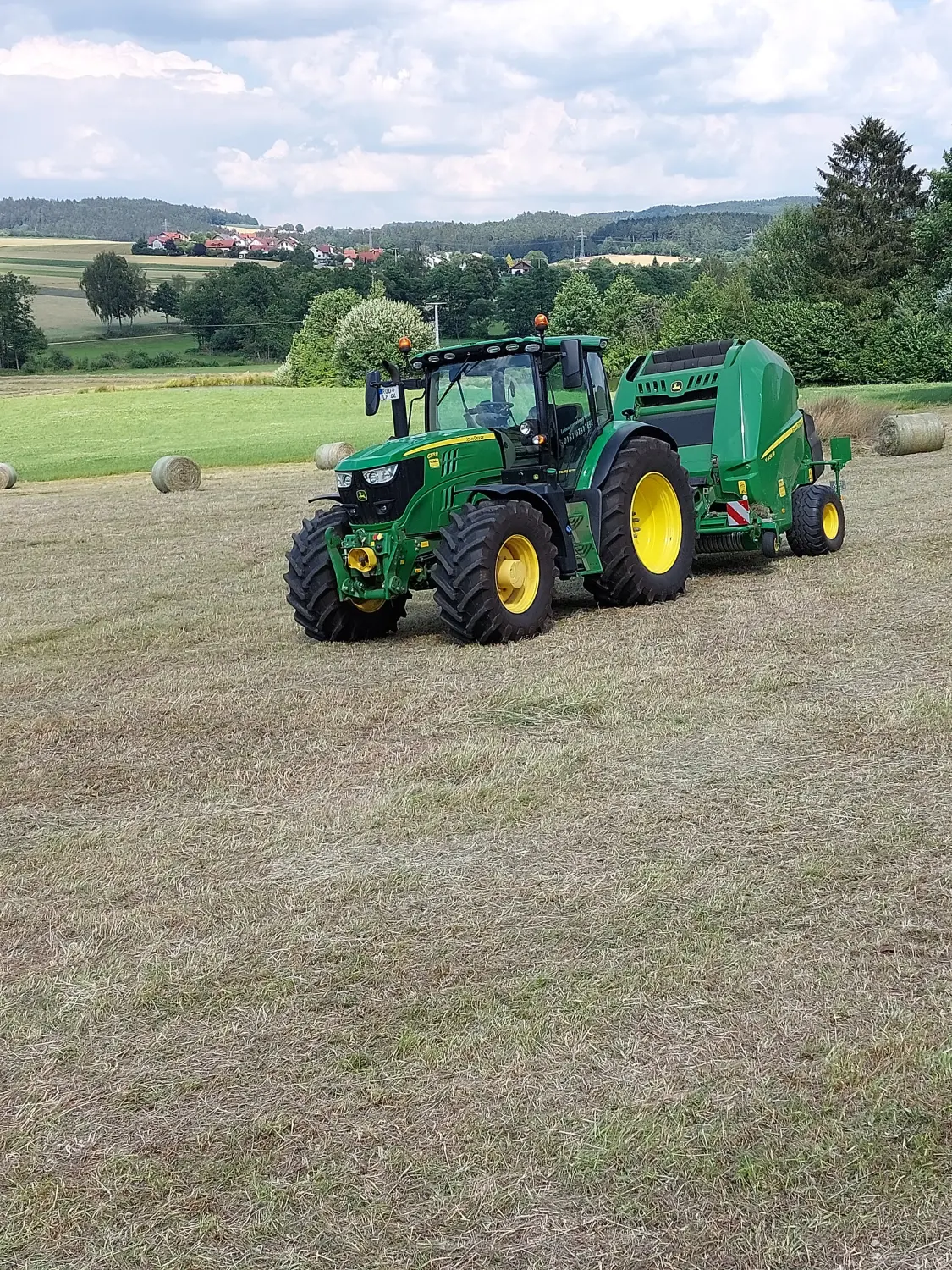 Pressen von Rundballen von Lohnunternehmen Meier